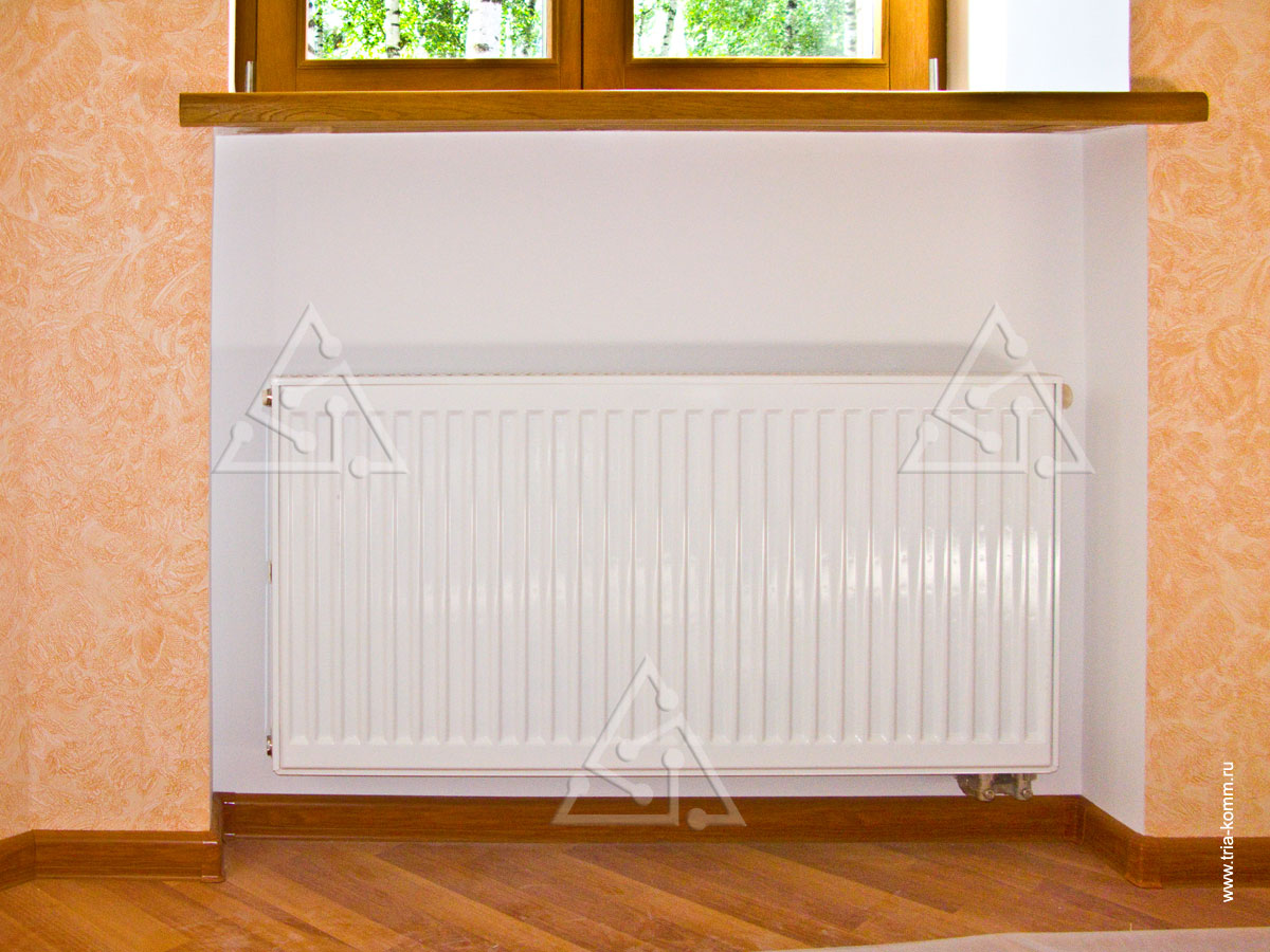 Фото панельного радиатора отопления в комнате загородного дома